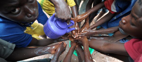 (FILES) A file picture taken on September 3, 2014 shows people washing their hands with soap and bleach to prevent the spread of the Ebola virus (FILES) A file picture taken on September 3, 2014 shows people washing their hands with soap and bleach to prevent the spread of the Ebola virus - Sputnik International