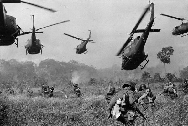 U.S. Army helicopters pour machine gun fire into the tree line to cover the advance of South Vietnamese ground troops in an attack on a Viet Cong camp 18 miles north of Tay Ninh, northwest of Saigon, March 1965. U.S. Army helicopters pour machine gun fire into the tree line to cover the advance of South Vietnamese ground troops in an attack on a Viet Cong camp 18 miles north of Tay Ninh, northwest of Saigon, March 1965. - Sputnik International