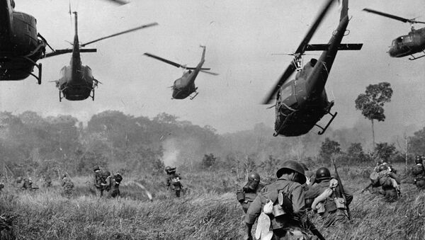 Hovering U.S. Army helicopters pour machine gun fire into the tree line to cover the advance of South Vietnamese ground troops in an attack on a Viet Cong camp 18 miles north of Tay Ninh, northwest of Saigon near the Cambodian border, in March 1965 during the Vietnam War - Sputnik International