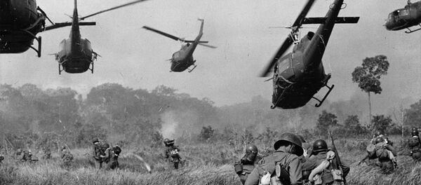 Hovering U.S. Army helicopters pour machine gun fire into the tree line to cover the advance of South Vietnamese ground troops in an attack on a Viet Cong camp 18 miles north of Tay Ninh, northwest of Saigon near the Cambodian border, in March 1965 during the Vietnam War Hovering U.S. Army helicopters pour machine gun fire into the tree line to cover the advance of South Vietnamese ground troops in an attack on a Viet Cong camp 18 miles north of Tay Ninh, northwest of Saigon near the Cambodian border, in March 1965 during the Vietnam War - Sputnik International