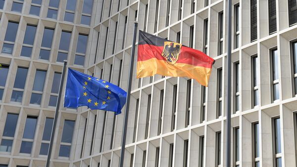 The German (R) and the European flag fly in the wind outside the new Federal Ministry of the Interior building in Berlin on April 26, 2015 - Sputnik International