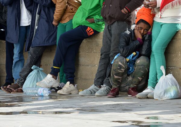 Migrants wait at the port of Lampedusa to board a ferry bound for Porto Empedocle in Sicily on February 20, 2015. Migrants wait at the port of Lampedusa to board a ferry bound for Porto Empedocle in Sicily on February 20, 2015. - Sputnik International