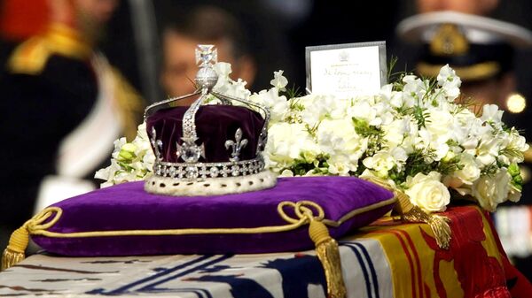 The Koh-i-noor, or mountain of light, diamond, set in the Maltese Cross at the front of the crown made for Britain's late Queen Mother Elizabeth, is seen on her coffin, along with her personal standard, a wreath and a note from her daughter, Queen Elizabeth II, as it is drawn to London's Westminster Hall in this April 5, 2002 file photo. - Sputnik International