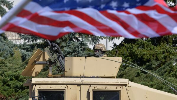 A US soldier looks from the armored vehicle Humvee as US military convoy arrives to the Czech army barracks on March 30, 2015 in Prague after entering the Czech Republic at the border crossing in Harrachov on the way from Baltic countries to base in Vilseck, southern Germany - Sputnik International