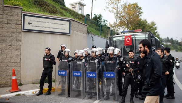 Riot police officers stand as members of Turkey Youth Union shout anti-US slogans as they protest against the upcoming visit of the US President Barack Obama to Turkey mid-November for G20 summit in Antalya, outside the US consulate in Istanbul, Turkey, Sunday, Nov. 8, 2015 - Sputnik International