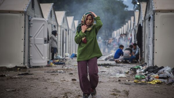 A woman walks inside the Moria camp for migrants and refugees on the northeastern Greek island of Lesbos, Saturday, Oct. 24, 2015 - Sputnik International