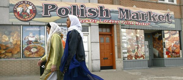 Muslim women walk past the Polish Market in downtown Hamtramck, Mich., Monday, April 19, 2004. In a sign of the deep changes in this once predominantly Polish town, City Council is expected Tuesday to pass a noise ordinance amendment that would permit mosques to issue the traditional call to prayer. But some longtime residents are resisting what they consider an affront to the religious freedom of non-Muslims. Muslim women walk past the Polish Market in downtown Hamtramck, Mich., Monday, April 19, 2004. In a sign of the deep changes in this once predominantly Polish town, City Council is expected Tuesday to pass a noise ordinance amendment that would permit mosques to issue the traditional call to prayer. But some longtime residents are resisting what they consider an affront to the religious freedom of non-Muslims. - Sputnik International
