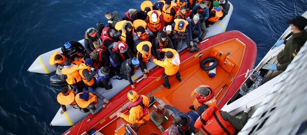 Refugees and migrants board the Turkish Coast Guard Search and Rescue ship Umut-703, off the shores of Canakkale, Turkey, after a failed attempt at crossing to the Greek island of Lesbos, November 9, 2015. Refugees and migrants board the Turkish Coast Guard Search and Rescue ship Umut-703, off the shores of Canakkale, Turkey, after a failed attempt at crossing to the Greek island of Lesbos, November 9, 2015. - Sputnik International
