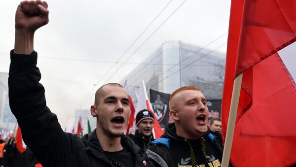 Demonstrators wave the Polish flag during the annual march commemorates Poland's National Independence Day in Warsaw on November 11, 2015. Poland's National Independence Day commemorates the anniversary of the Restoration of a Polish State in 1918. - Sputnik International