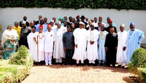 Nigerian President Mohammadu Buhari (C) poses for a family photo with newly-appointed ministers after the swearing in ceremony in Abuja, on November 11, 2015. - Sputnik International