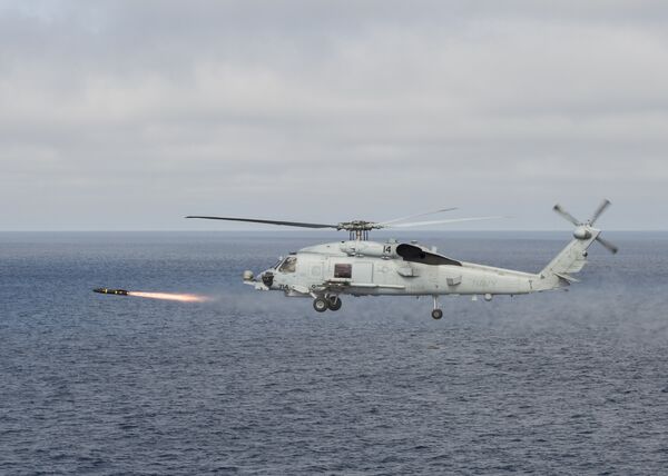 An MH-60R Sea Hawk helicopter attached to the Raptors of Helicopter Maritime Strike Squadron (HSM) 71 fires an AGM-114 Hellfire missile during a training exercise over the Pacific Ocean An MH-60R Sea Hawk helicopter attached to the Raptors of Helicopter Maritime Strike Squadron (HSM) 71 fires an AGM-114 Hellfire missile during a training exercise over the Pacific Ocean - Sputnik International