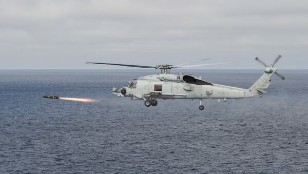 An MH-60R Sea Hawk helicopter attached to the Raptors of Helicopter Maritime Strike Squadron (HSM) 71 fires an AGM-114 Hellfire missile during a training exercise over the Pacific Ocean - Sputnik International
