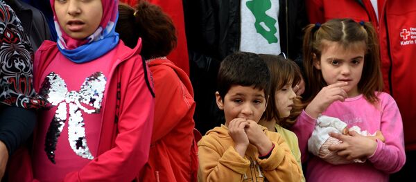 Young migrants wait for the arrival of the German President at an accommodation for refugees in Bergisch Gladbach, western Germany, on November 12, 2015. - Sputnik International