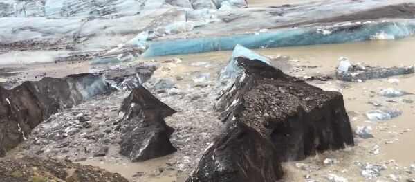 Iceberg Covered with Volcanic Ash Breaking Off from Svinafellsjokull Glacier in Iceland - AMAZING! Iceberg Covered with Volcanic Ash Breaking Off from Svinafellsjokull Glacier in Iceland - AMAZING! - Sputnik International