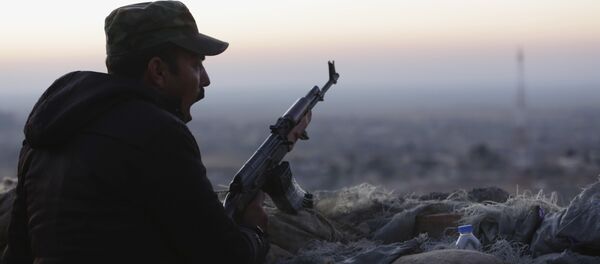A Kurdish fighter, known as a peshmerga, yawns as he stands guard on the frontline in Sinjar, Iraq, Friday, Nov. 13, 2015. - Sputnik International