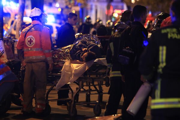 A person is being evacuated after a shooting, outside the Bataclan theater in Paris, Friday Nov. 13, 2015. A person is being evacuated after a shooting, outside the Bataclan theater in Paris, Friday Nov. 13, 2015. - Sputnik International