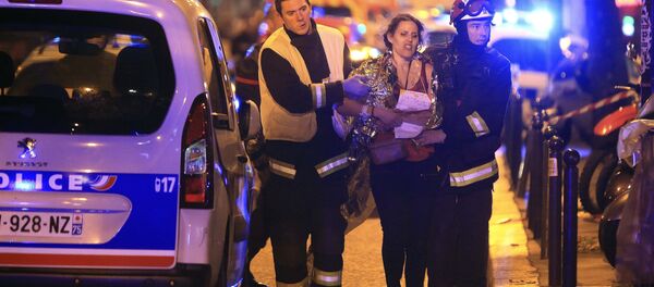 Rescue workers help a woman after a shooting, outside the Bataclan theater in Paris,November 13,2015 Rescue workers help a woman after a shooting, outside the Bataclan theater in Paris,November 13,2015 - Sputnik International