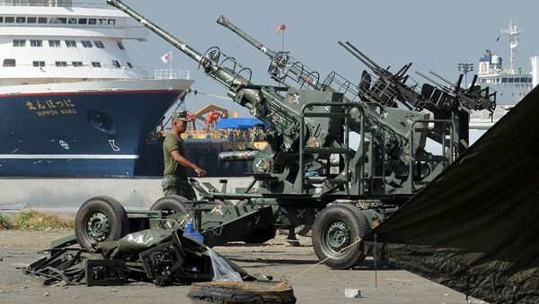 Philippine marine walks beside anti-aircraft guns in Manila on November 14, 2015, ahead of the Asia-Pacific Economic Cooperation (APEC) summit. The Philippines November 14 vowed higher security for world leaders at an economic summit in Manila next week after a series of bombings and shootings left more than 120 dead in Paris - Sputnik International
