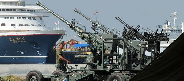 Philippine marine walks beside anti-aircraft guns in Manila on November 14, 2015, ahead of the Asia-Pacific Economic Cooperation (APEC) summit. The Philippines November 14 vowed higher security for world leaders at an economic summit in Manila next week after a series of bombings and shootings left more than 120 dead in Paris Philippine marine walks beside anti-aircraft guns in Manila on November 14, 2015, ahead of the Asia-Pacific Economic Cooperation (APEC) summit. The Philippines November 14 vowed higher security for world leaders at an economic summit in Manila next week after a series of bombings and shootings left more than 120 dead in Paris - Sputnik International