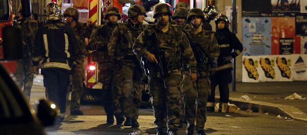 Soldiers walk in front of an ambulance as rescue workers evacuate victims near La Belle Equipe, rue de Charonne, at the site of an attack on Paris on November 14, 2015 Soldiers walk in front of an ambulance as rescue workers evacuate victims near La Belle Equipe, rue de Charonne, at the site of an attack on Paris on November 14, 2015 - Sputnik International