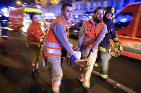 A woman is being evacuated from the Bataclan theater after a shooting in Paris, Friday Nov. 13, 2015. A woman is being evacuated from the Bataclan theater after a shooting in Paris, Friday Nov. 13, 2015. - Sputnik International