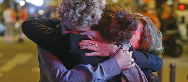 People hug on the street near the Bataclan concert hall following fatal attacks in Paris, France, November 14, 2015 People hug on the street near the Bataclan concert hall following fatal attacks in Paris, France, November 14, 2015 - Sputnik International