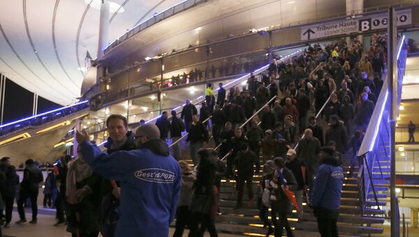 Crowds leave the Stade de France where explosions were reported to have detonated outside the stadium during the France vs German friendly match near Paris, November 13, 2015 - Sputnik International