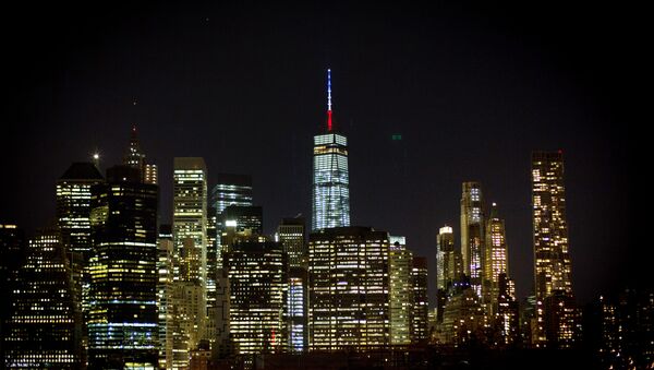 The One World Trade Center spire is lit blue, white and red after New York Gov. Andrew Cuomo announced the lighting in honor of dozens killed in the Paris attacks Friday, Nov. 13, 2015, in New York - Sputnik International