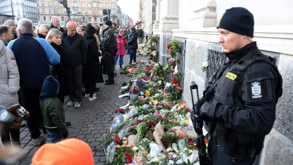 People place flowers in front of the French Embassy in Copenhagen, Denmark, Saturday, Nov. 14, 2015, as people gather with condolences for the victims of Friday's attacks in Paris - Sputnik International