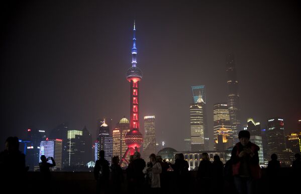 The Oriental Pearl TV Tower in Shanghai, China, was lit in red, white and blue for one hour, resembling the colors of the French flag, as the Chinese expressed their solidarity with France after eight extremists wearing explosive belts attacked several venues across Paris, killing 129 people. - Sputnik International