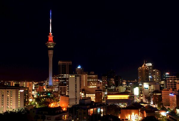 The Sky Tower in Auckland, New Zealand is lit up in the French national colors in solidarity with France after eight extremists wearing explosive belts attacked several venues across Paris, killing 129 people. - Sputnik International