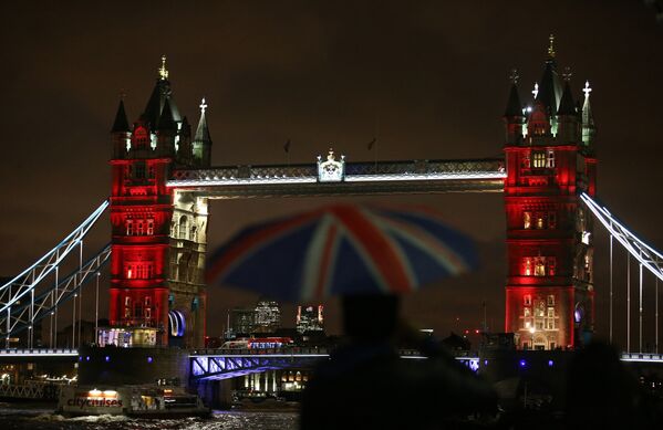 London's iconic Tower Bridge is illuminated in blue, white and red lights, resembling the colors of the French national flag as Britons express their solidarity with France following a spate of coordinated attacks that left 128 dead in Paris on November 13. - Sputnik International