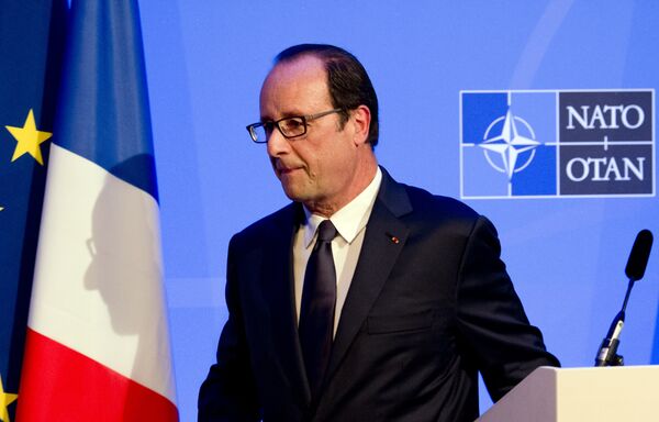 A shadow of France's President Francois Hollande is cast on a flag as he leaves a press conference on the second day of the NATO 2014 Summit at the Celtic Manor Resort in Newport, South Wales, on September 5, 2014 A shadow of France's President Francois Hollande is cast on a flag as he leaves a press conference on the second day of the NATO 2014 Summit at the Celtic Manor Resort in Newport, South Wales, on September 5, 2014 - Sputnik International