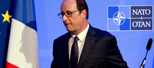 A shadow of France's President Francois Hollande is cast on a flag as he leaves a press conference on the second day of the NATO 2014 Summit at the Celtic Manor Resort in Newport, South Wales, on September 5, 2014 A shadow of France's President Francois Hollande is cast on a flag as he leaves a press conference on the second day of the NATO 2014 Summit at the Celtic Manor Resort in Newport, South Wales, on September 5, 2014 - Sputnik International