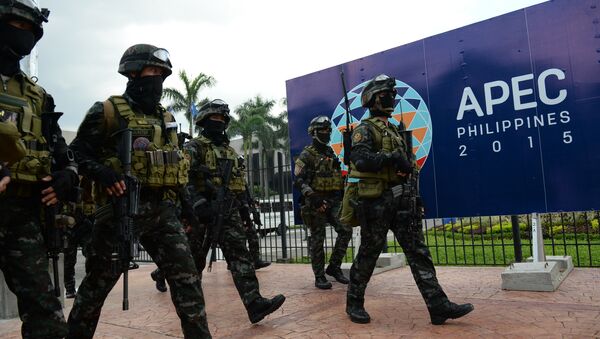 Members of the police Special Action Force (SAF) walk in front of signage for the Asia-Pacific Economic Cooperation (APEC) summit after a drill simulating a Paris-like attack at the convention center, the venue of the summit in Manila on November 14, 2015 - Sputnik International