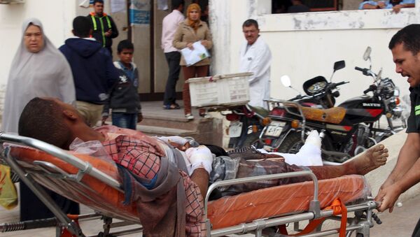 An African migrant, who was wounded during gunfire near the border with Israel, lies on a stretcher as he is taken to the hospital at Al Arish city, in the northern part of Sinai peninsula, Egypt, November 15, 2015 - Sputnik International