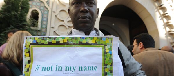 File photo of a man holds a placard reading Not in my name during a demonstration called by muslims groups to denounce the barbarism of Islamic State militants, on September 26, 2014 outside Paris's main mosque File photo of a man holds a placard reading Not in my name during a demonstration called by muslims groups to denounce the barbarism of Islamic State militants, on September 26, 2014 outside Paris's main mosque - Sputnik International
