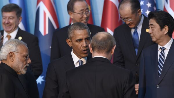President Barack Obama, center, talks with Russia’s President Vladimir Putin, center right, as they arrive for a group photo with other leaders for the G-20 Summit in Antalya, Turkey, Sunday, Nov. 15, 2015 - Sputnik International