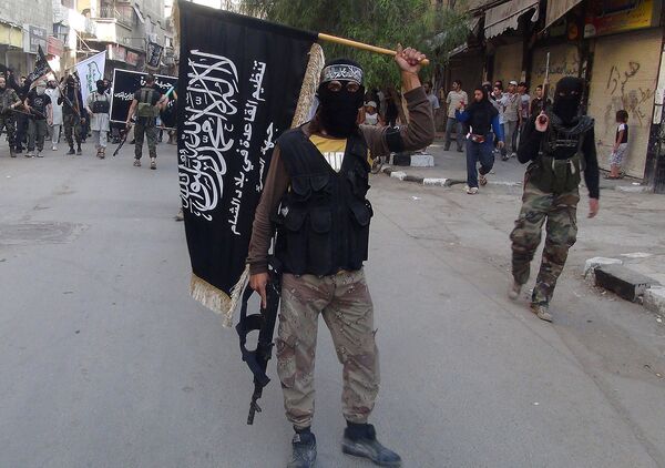 Islamic fighters from the al-Qaida group in the Levant, Al-Nusra Front, wave their movement's flag as they parade at the Yarmuk Palestinian refugee camp, south of Damascus, to denounce Israel’s military offensive on the Gaza Strip, on July 28, 2014 Islamic fighters from the al-Qaida group in the Levant, Al-Nusra Front, wave their movement's flag as they parade at the Yarmuk Palestinian refugee camp, south of Damascus, to denounce Israel’s military offensive on the Gaza Strip, on July 28, 2014 - Sputnik International