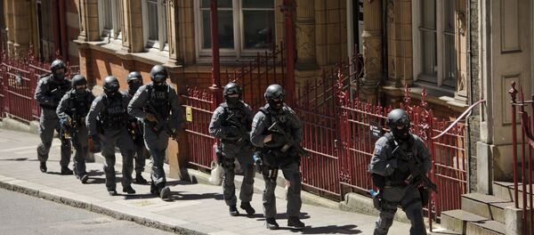 During a training exercise for London's emergency services, armed police officers walk towards the disused Aldwych underground train station in London, Tuesday, June 30, 2015 - Sputnik International