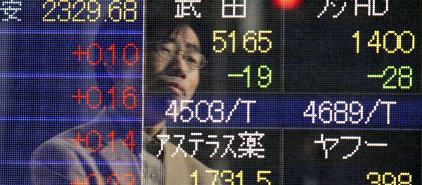 A man is reflected on an electronic board of a securities firm in Tokyo Friday, Jan. 16, 2015. A man is reflected on an electronic board of a securities firm in Tokyo Friday, Jan. 16, 2015. - Sputnik International