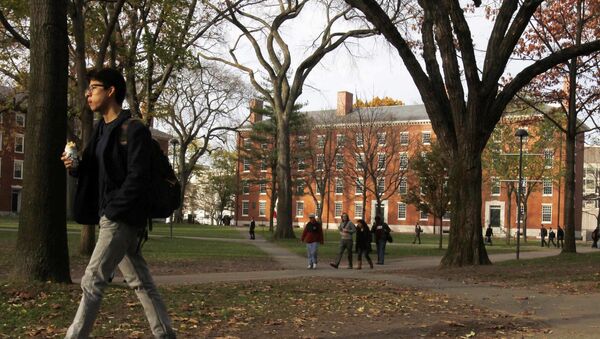 A student walks through Harvard Yard at Harvard University in Cambridge, Massachusetts, in this file photo taken November 16, 2012 - Sputnik International