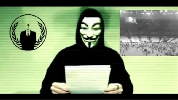 Still image from a video shows a man wearing a mask associated with Anonymous making a statement - Sputnik International