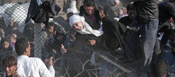 FILE - In this Sunday, June 14, 2015 file photo, Syrian refugees are helped into Turkey after breaking the border fence and crossing from Syria in Akcakale, Sanliurfa province, southeastern Turkey FILE - In this Sunday, June 14, 2015 file photo, Syrian refugees are helped into Turkey after breaking the border fence and crossing from Syria in Akcakale, Sanliurfa province, southeastern Turkey - Sputnik International