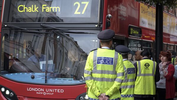 Police officers stand guard at a bus stop outside Paddington Station in London. - Sputnik International