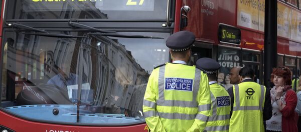 Police officers stand guard at a bus stop outside Paddington Station in London. Police officers stand guard at a bus stop outside Paddington Station in London. - Sputnik International