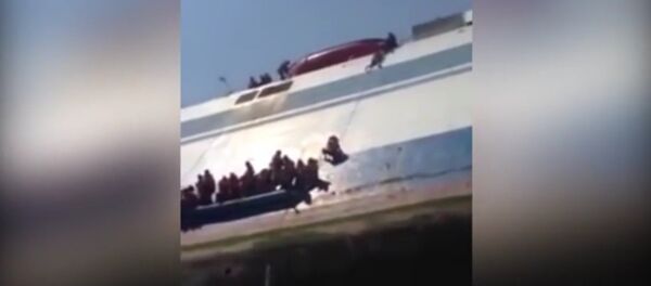 Scared passengers cling to the side of capsized ferry. Scared passengers cling to the side of capsized ferry. - Sputnik International