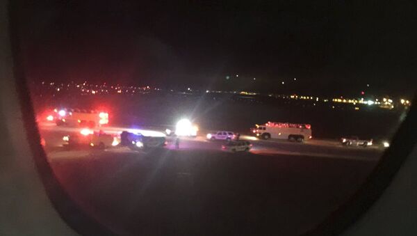 Emergency personnel are shown on the tarmac at Salt Lake City International Airport in this photograph taken by passenger Keith Rosso from a seat inside Air France flight 65, November 17, 2015 - Sputnik International