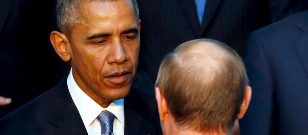U.S. President Barack Obama shakes hands with Russia's President Vladimir Putin (back to camera) as they gather for a family photo with fellow world leaders at the start of the G20 summit at the Regnum Carya Resort in Antalya, Turkey, November 15, 2015 - Sputnik International
