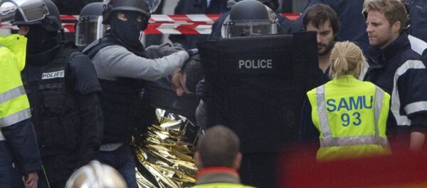Hooded police officers detain a man in Saint-Denis, near Paris, Wednesday, Nov. 18, 2015. A woman wearing an explosive suicide vest blew herself up Wednesday as heavily armed police tried to storm a suburban Paris apartment where the suspected mastermind of last week's attacks was believed to be holed up, police said. Hooded police officers detain a man in Saint-Denis, near Paris, Wednesday, Nov. 18, 2015. A woman wearing an explosive suicide vest blew herself up Wednesday as heavily armed police tried to storm a suburban Paris apartment where the suspected mastermind of last week's attacks was believed to be holed up, police said. - Sputnik International